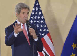 John Kerry, holding a microphone