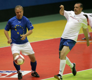 Rehn (former professional soccer player) dribbles Recep Tayyip Erdogan, the Turkish Prime Minister, in a benefit game in 2006