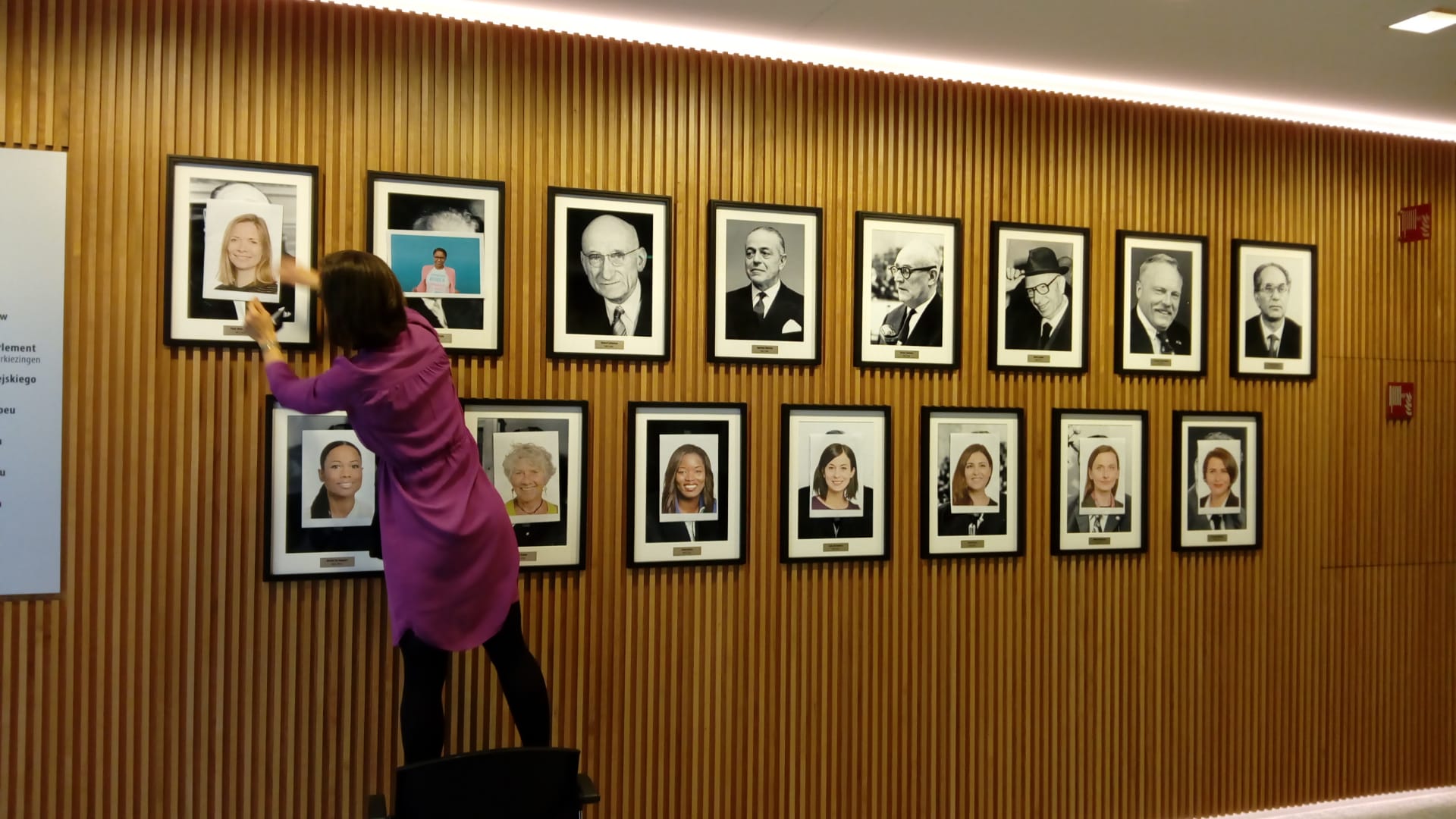 Hannah Neumann mentre incolla i volti di donna sugli uomini ex presidenti del Parlamento europeo [Bruxelles, 8 marzo 2021]