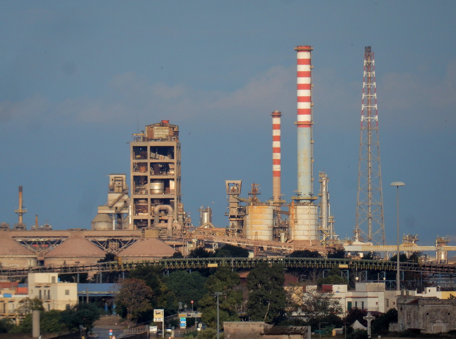 Taranto, Puglia, Italy - November 2, 2019: Chimneys of the Arcelor Mittal steel plant in the Tamburi district early in the morning