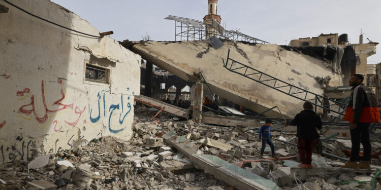 People inspect the damage in the rubble of a mosque following Israeli bombardment, in Rafah, on the southern Gaza Strip on February 12, 2024, amid ongoing battles between Israel and the Palestinian militant group Hamas. (Photo by MOHAMMED ABED / AFP)