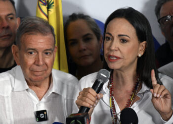 Venezuelan opposition leader Maria Corina Machado talks to the media next to opposition presidential candidate Edmundo Gonzalez Urrutia, following the presidential election results in Caracas on July 29, 2024. Venezuela's opposition coalition on Monday rejected the election victory claimed by President Nicolas Maduro and announced by a loyalist electoral authority, saying it had garnered 70 percent of the vote, not 44 percent as reported by the authority. (Photo by Federico PARRA / AFP)