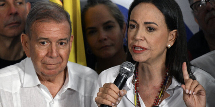 Venezuelan opposition leader Maria Corina Machado talks to the media next to opposition presidential candidate Edmundo Gonzalez Urrutia, following the presidential election results in Caracas on July 29, 2024. Venezuela's opposition coalition on Monday rejected the election victory claimed by President Nicolas Maduro and announced by a loyalist electoral authority, saying it had garnered 70 percent of the vote, not 44 percent as reported by the authority. (Photo by Federico PARRA / AFP)