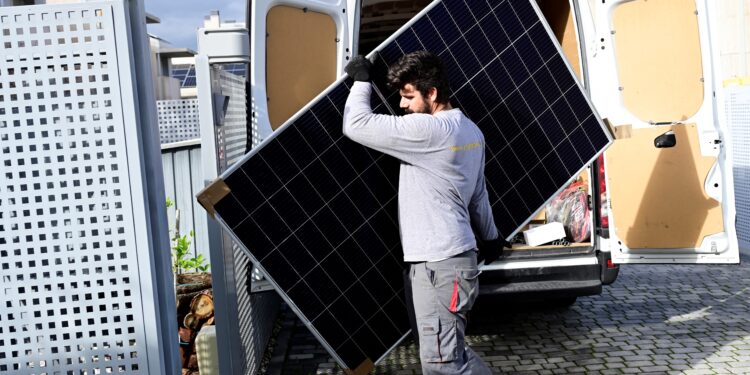 An employee of the company EngelSolar holds a solar panel in Boadilla del Monte near Madrid on December 21, 2022. Demand for solar panels has shot up to "unprecedented" levels in Spain as Europe's energy crisis shows no sign of letting up in a welcome boost for a sector with huge potential. (Photo by JAVIER SORIANO / AFP)