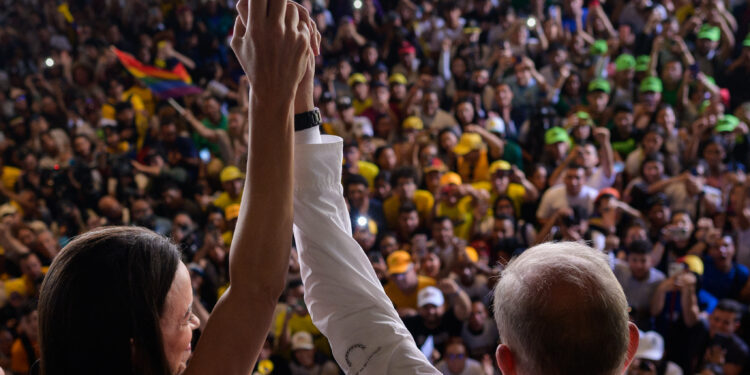 (FILES) Venezuelan presidential candidate Edmundo Gonzalez (R) and Venezuelan opposition leader Maria Corina Machado greet students during a campaign rally at the Central University of Venezuela in Caracas on July 14, 2024 (Photo by Gabriela Oraa / AFP)