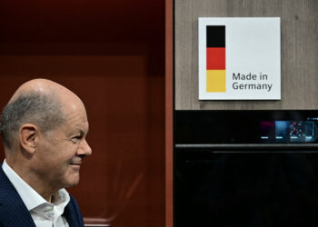 German Chancellor Olaf Scholz stands next to a sign reading "Made in Germany" at the booth of "Siemens" during his opening tour of the 100th edition of the "Internationale Funkausstellung" (IFA), the international trade show for consumer electronics and home appliances, on September 6, 2024 in Berlin. (Photo by Tobias SCHWARZ / AFP)