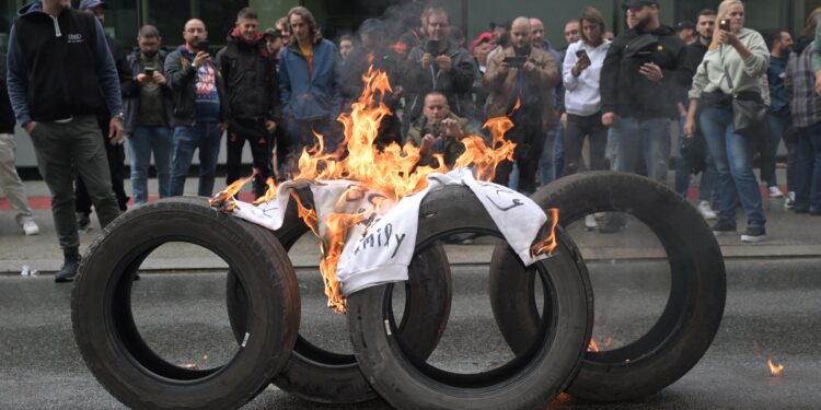 Workers block the entrance to the Audi Brussels plant, in Vorst-Forest, in Brussels, on September 9, 2024. The management announced on September 8 that the plant would remain closed until workers agreed to resume production and deliver cars to dealers. The unions confiscated last week the keys of some 200 cars till they have clarity on the future of the plant. (Photo by JONAS ROOSENS / Belga / AFP) / Belgium OUT