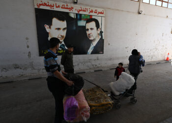 A family arrives in Syria's Jousieh border crossing after crossing from Lebanon on October 28, 2024. (Photo by LOUAI BESHARA / AFP)