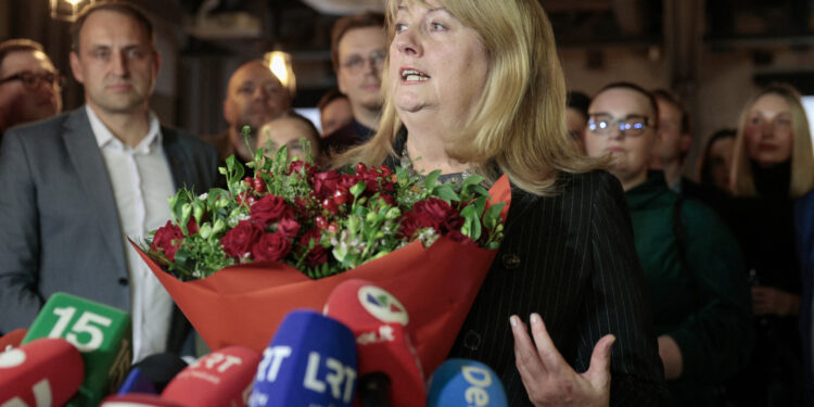 Vilija Blinkeviciute, leader of Lithuania's Social Democratic Party holds a bouquet of flowers and talks with journalists as exit poll results are announced in Vilnius, Lithuania, during the second round of parliamentary elections on October 27, 2024. Lithuania's centre-left opposition won a clear victory in the October 27, 2024 parliamentary election, preliminary results showed, after a campaign dominated by concerns about the cost of living and social inequality. The Social Democratic Party came first with 52 seats in the 141-seat parliament and is now hoping to build a coalition. (Photo by Petras Malukas / AFP)